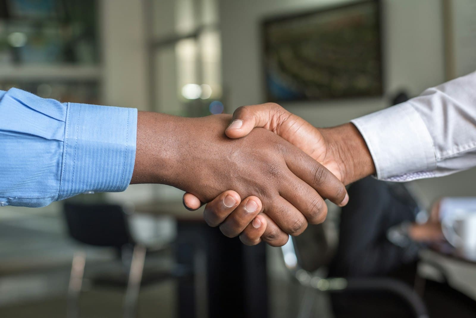 Two parties shaking hands over a supply agreement