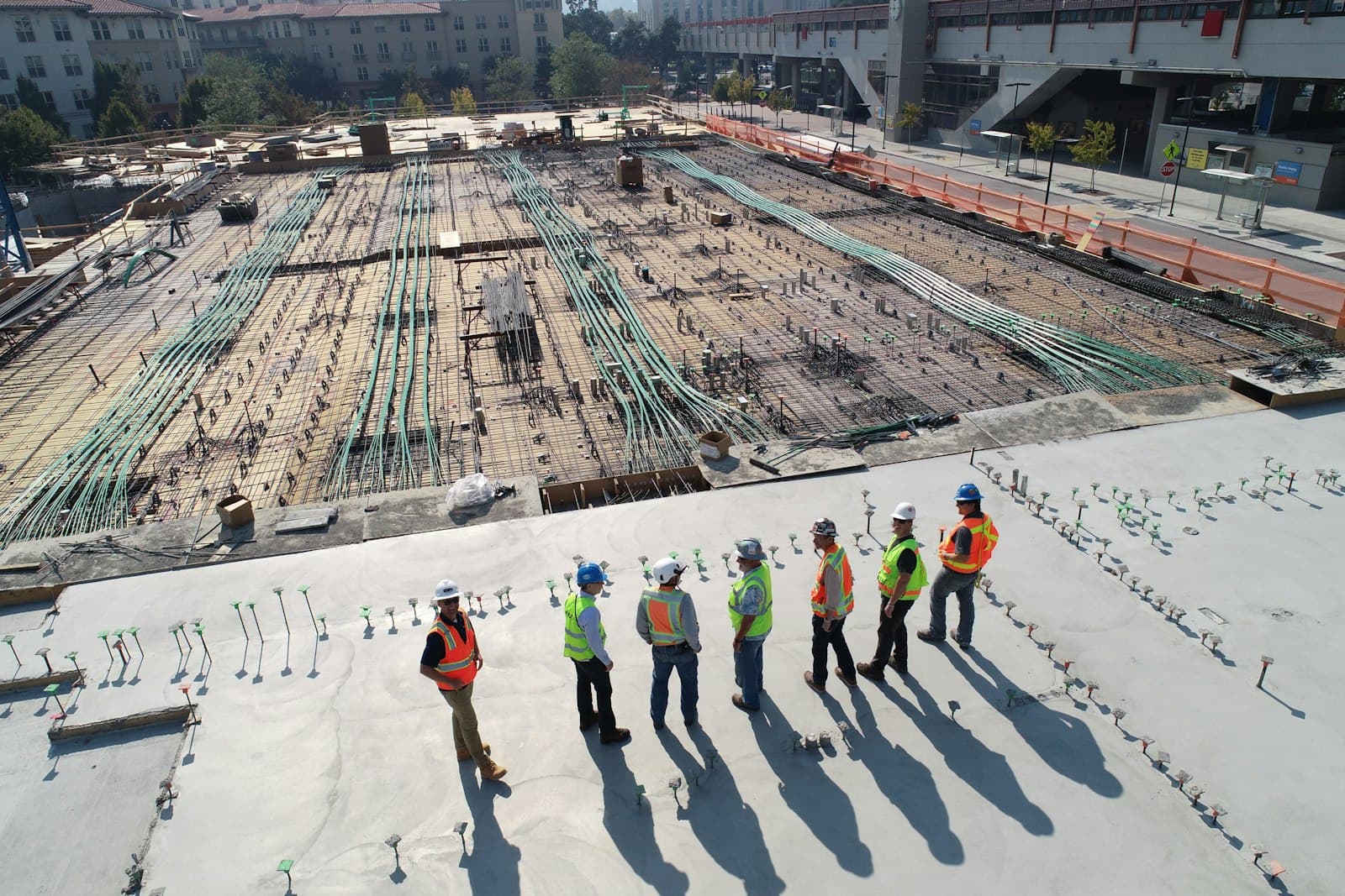 A large active construction site with crews and materials laid out across the slab